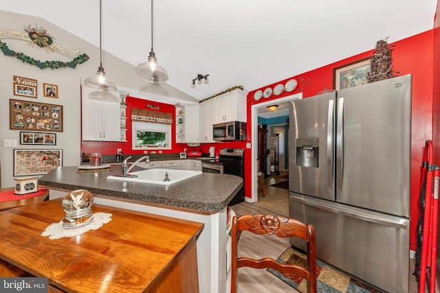 343 Mill Farm Trl, Berkeley Springs, WV 25411 - kitchen with appliances with stainless steel finishes, a sink, vaulted ceiling, dark countertops, and white cabinets