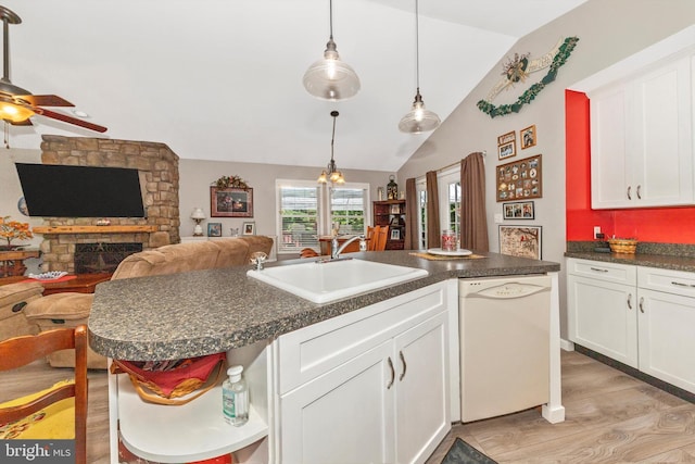 343 Mill Farm Trl, Berkeley Springs, WV 25411 - kitchen featuring white dishwasher, a sink, vaulted ceiling, white cabinetry, and dark countertops