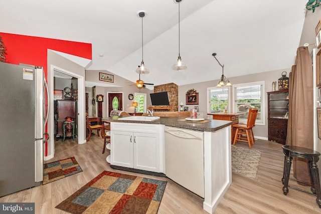 343 Mill Farm Trl, Berkeley Springs, WV 25411 - kitchen featuring freestanding refrigerator, dishwasher, lofted ceiling, dark countertops, and white cabinets