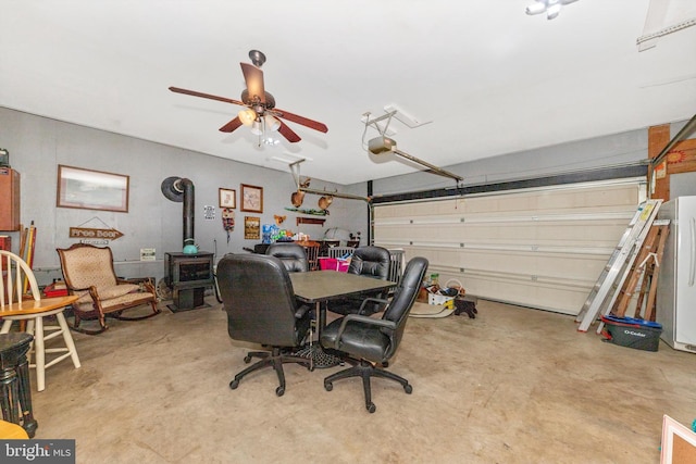 343 Mill Farm Trl, Berkeley Springs, WV 25411 - garage with a wood stove, a garage door opener, and ceiling fan