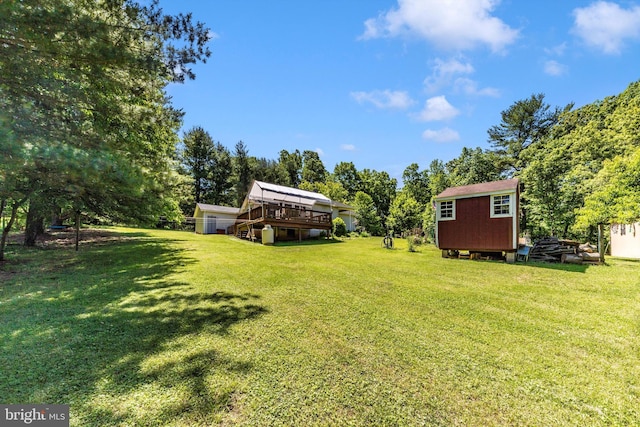 343 Mill Farm Trl, Berkeley Springs, WV 25411 - view of grassy yard featuring a deck and view of wooded area