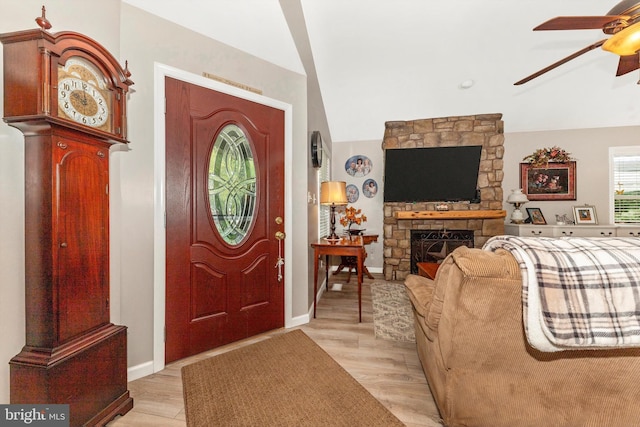 343 Mill Farm Trl, Berkeley Springs, WV 25411 - foyer entrance with ceiling fan, light wood-style flooring, lofted ceiling, baseboards, and a stone fireplace