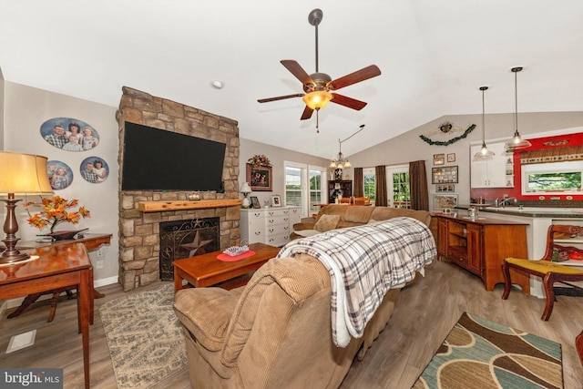 343 Mill Farm Trl, Berkeley Springs, WV 25411 - living area with lofted ceiling, ceiling fan, light wood-type flooring, and a stone fireplace