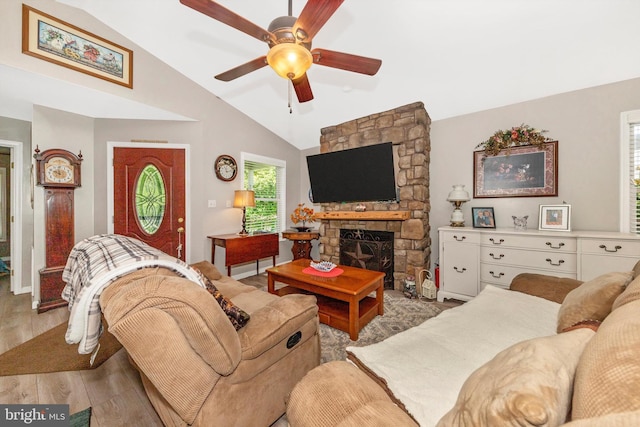 343 Mill Farm Trl, Berkeley Springs, WV 25411 - living area with vaulted ceiling, a ceiling fan, light wood finished floors, and a stone fireplace