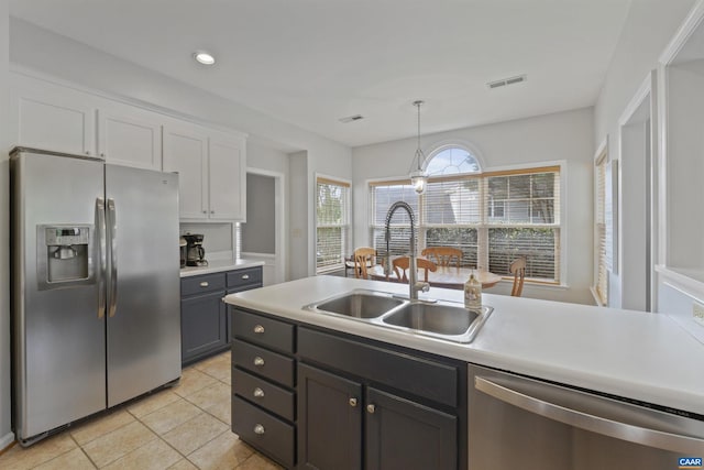 989 Clearfields Ln, Crozet, VA 22932 - kitchen featuring stainless steel appliances, a sink, hanging light fixtures, light tile patterned flooring, and light countertops