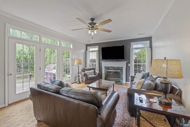 989 Clearfields Ln, Crozet, VA 22932 - living room with ornamental molding, light wood-style floors, a fireplace, a ceiling fan, and baseboards