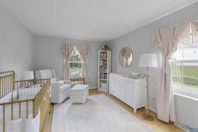 989 Clearfields Ln, Crozet, VA 22932 - bedroom with light wood-style floors, a nursery area, and baseboards