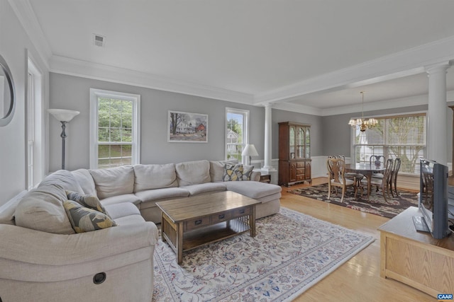 989 Clearfields Ln, Crozet, VA 22932 - living room featuring ornate columns, ornamental molding, a chandelier, and light wood finished floors