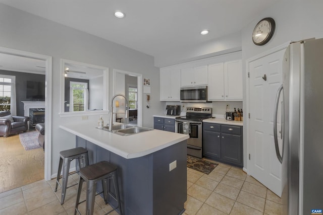 989 Clearfields Ln, Crozet, VA 22932 - kitchen featuring appliances with stainless steel finishes, a sink, a breakfast bar, white cabinets, and light countertops