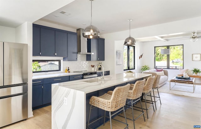 983 5th St SW, Charlottesville, VA 22902 - kitchen featuring appliances with stainless steel finishes, blue cabinets, open floor plan, a breakfast bar, and backsplash