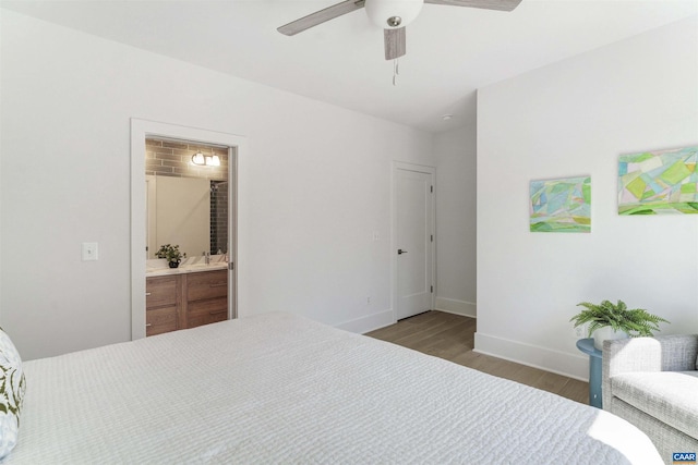 983 5th St SW, Charlottesville, VA 22902 - bedroom with wood finished floors, baseboards, connected bathroom, and a ceiling fan