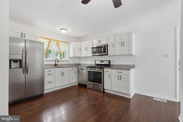 7 Breckenridge Dr, Sicklerville, NJ 08081 - kitchen featuring appliances with stainless steel finishes, ceiling fan, white cabinetry, dark wood-type flooring, and baseboards