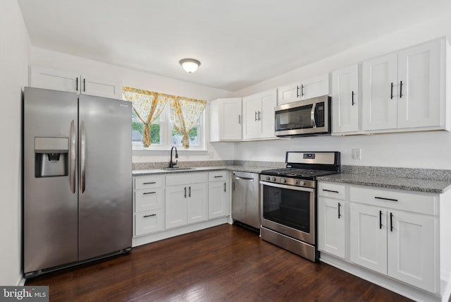 7 Breckenridge Dr, Sicklerville, NJ 08081 - kitchen featuring stainless steel appliances, white cabinets, a sink, light stone countertops, and dark wood-style flooring