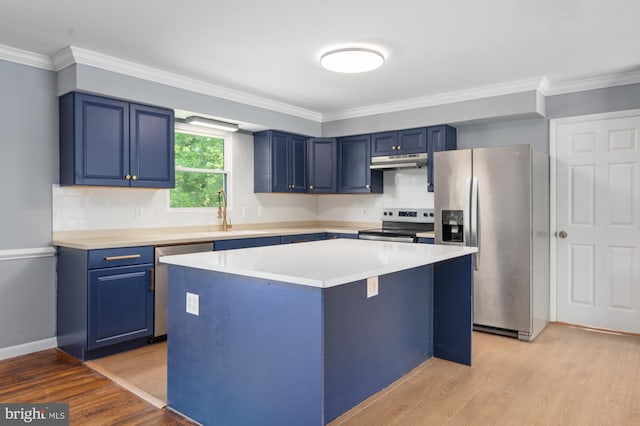 220 Firetower Rd, Port Deposit, MD 21904 - kitchen featuring appliances with stainless steel finishes, blue cabinetry, under cabinet range hood, light wood-type flooring, and crown molding