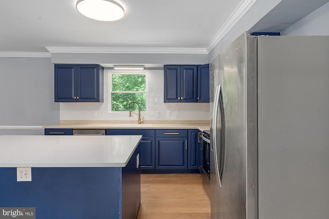 220 Firetower Rd, Port Deposit, MD 21904 - kitchen featuring freestanding refrigerator, blue cabinets, a sink, crown molding, and light wood-style floors