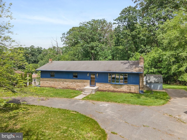 220 Firetower Rd, Port Deposit, MD 21904 - single story home with a chimney, stone siding, a front lawn, and asphalt driveway