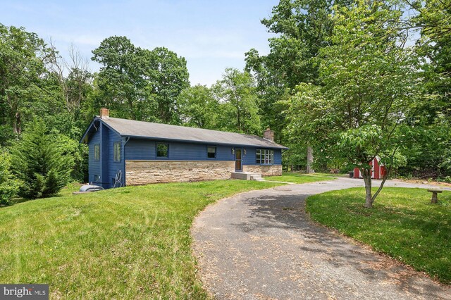 220 Firetower Rd, Port Deposit, MD 21904 - view of front facade featuring a chimney, curved driveway, a front lawn, and stone siding