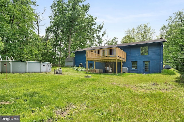 220 Firetower Rd, Port Deposit, MD 21904 - back of house with a wooden deck, a yard, an outdoor pool, and central air condition unit