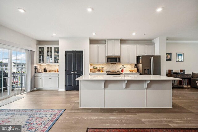 144 Bishop Way, Dublin, PA 18917 - kitchen with appliances with stainless steel finishes, a sink, light countertops, decorative backsplash, and a center island with sink