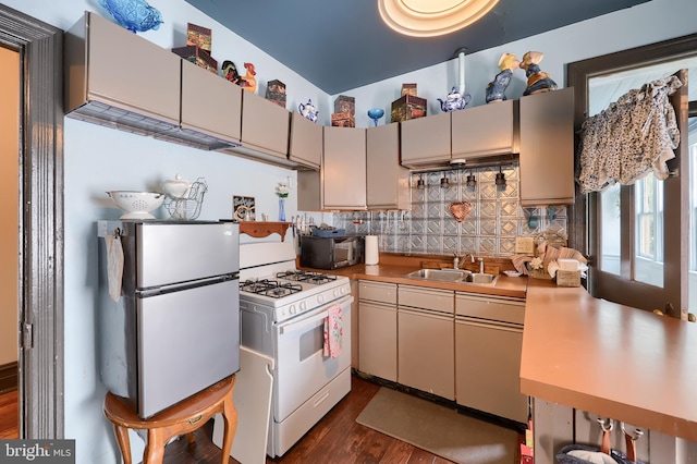 342 N Newberry St, York, PA 17401 - kitchen with freestanding refrigerator, white range with gas cooktop, dark wood-style flooring, light countertops, and backsplash
