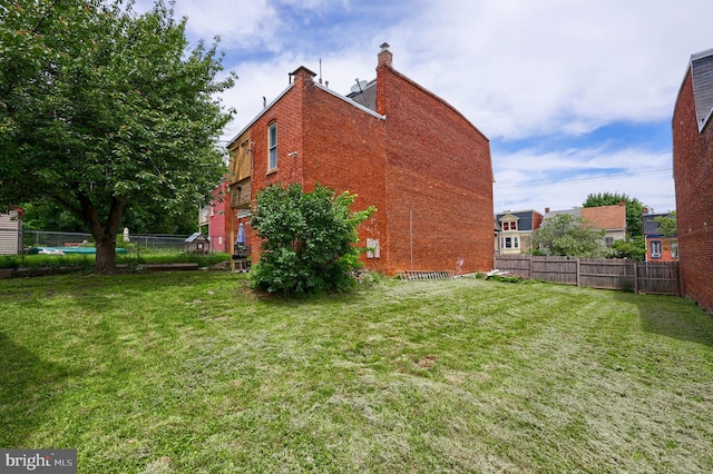 342 N Newberry St, York, PA 17401 - view of side of property featuring brick siding and a chimney