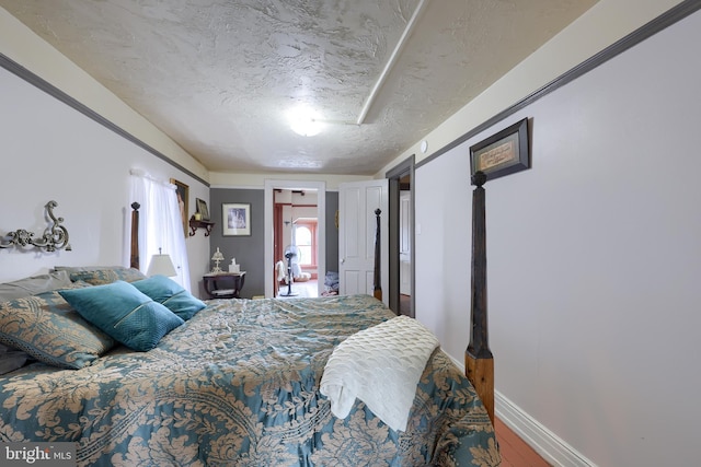342 N Newberry St, York, PA 17401 - bedroom with a textured ceiling, wood finished floors, and baseboards