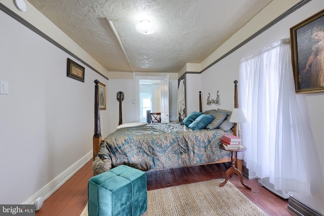 342 N Newberry St, York, PA 17401 - bedroom with wood-type flooring, a textured ceiling, and baseboards