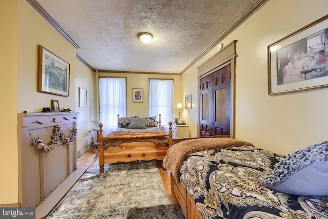 342 N Newberry St, York, PA 17401 - bedroom with ornamental molding, a textured ceiling, and wood finished floors
