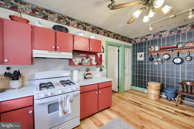 342 N Newberry St, York, PA 17401 - kitchen featuring red cabinets, gas range gas stove, under cabinet range hood, ceiling fan, and light wood-style floors
