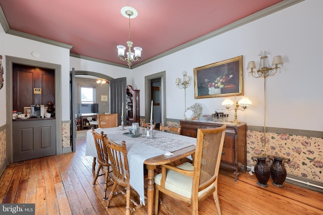 342 N Newberry St, York, PA 17401 - dining area featuring arched walkways, a chandelier, light wood-style floors, and crown molding