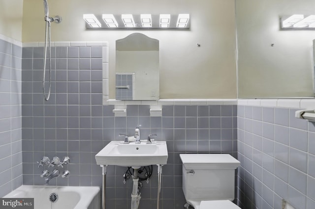 4200 Cathedral Ave NW Unit 317, Washington, DC 20016 - full bathroom with tile walls, toilet, shower / bathtub combination, a sink, and a wainscoted wall