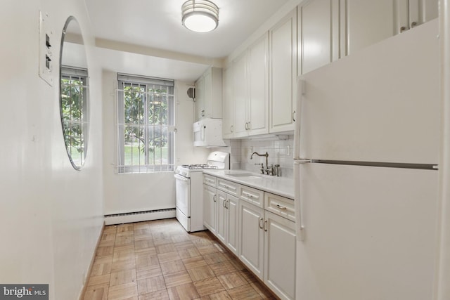 4200 Cathedral Ave NW Unit 317, Washington, DC 20016 - kitchen with white appliances, a baseboard heating unit, a sink, light countertops, and decorative backsplash