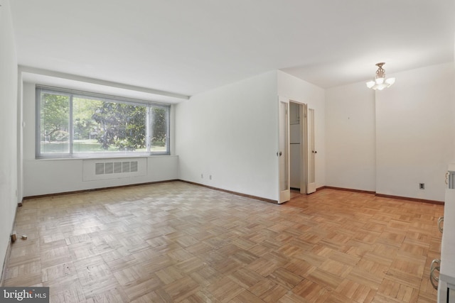 4200 Cathedral Ave NW Unit 317, Washington, DC 20016 - spare room featuring baseboards and a chandelier