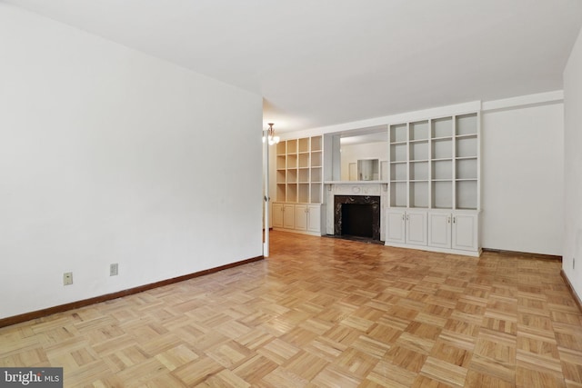 4200 Cathedral Ave NW Unit 317, Washington, DC 20016 - unfurnished living room featuring baseboards and a fireplace