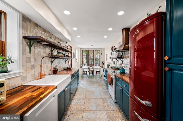 522 S Hanover St, Baltimore, MD 21201 - kitchen featuring butcher block counters, open shelves, white electric stove, dishwashing machine, and blue cabinetry