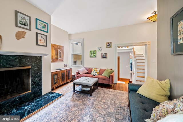 522 S Hanover St, Baltimore, MD 21201 - living area featuring a premium fireplace, stairway, and wood finished floors