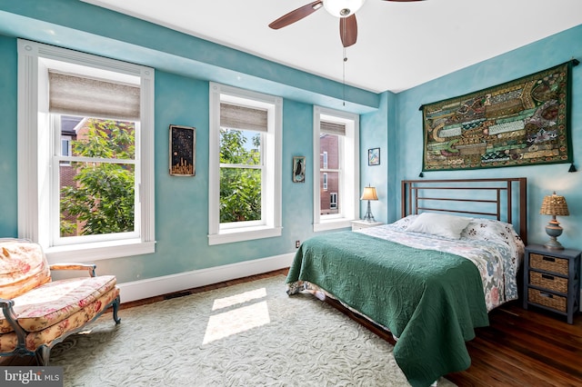 522 S Hanover St, Baltimore, MD 21201 - bedroom featuring multiple windows, baseboards, wood finished floors, and ceiling fan