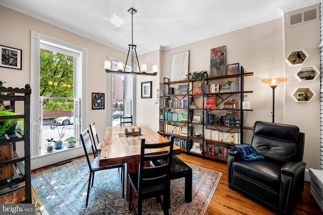 522 S Hanover St, Baltimore, MD 21201 - dining room with ornamental molding, hardwood / wood-style flooring, and a chandelier
