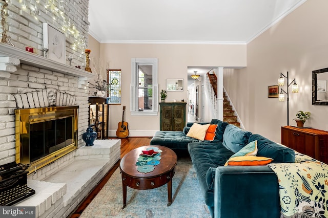 522 S Hanover St, Baltimore, MD 21201 - living area featuring wood finished floors, ornamental molding, a brick fireplace, stairs, and baseboards