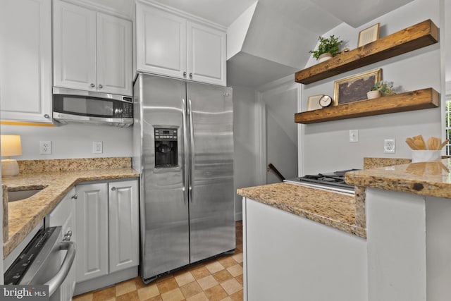 823 Church St, Alexandria, VA 22314 - kitchen featuring appliances with stainless steel finishes, open shelves, white cabinetry, and light stone countertops