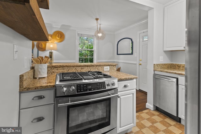 823 Church St, Alexandria, VA 22314 - kitchen featuring appliances with stainless steel finishes, a peninsula, white cabinetry, ornamental molding, and light stone counters