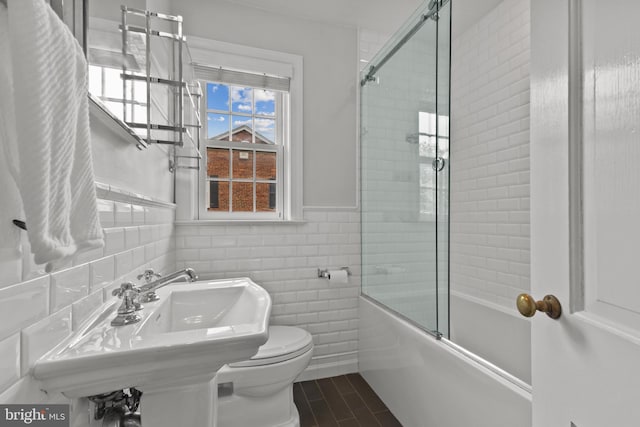 823 Church St, Alexandria, VA 22314 - full bath with toilet, bath / shower combo with glass door, tile walls, and a wainscoted wall