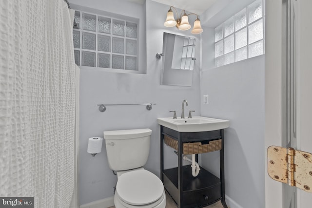 823 Church St, Alexandria, VA 22314 - full bathroom featuring toilet, baseboards, curtained shower, and a sink