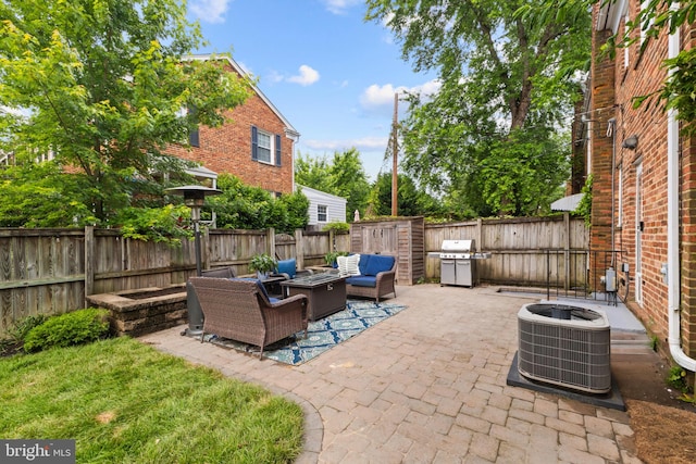 823 Church St, Alexandria, VA 22314 - fenced backyard with central AC unit, an outdoor living space with a fire pit, a patio, and a grill