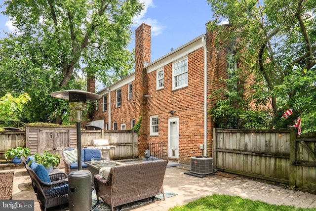 823 Church St, Alexandria, VA 22314 - back of property with a patio area, an outdoor living space, a fenced backyard, and brick siding