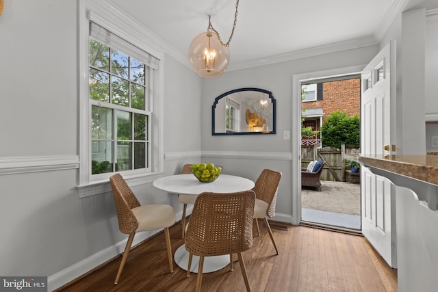 823 Church St, Alexandria, VA 22314 - dining room with ornamental molding, a chandelier, light wood-type flooring, and baseboards