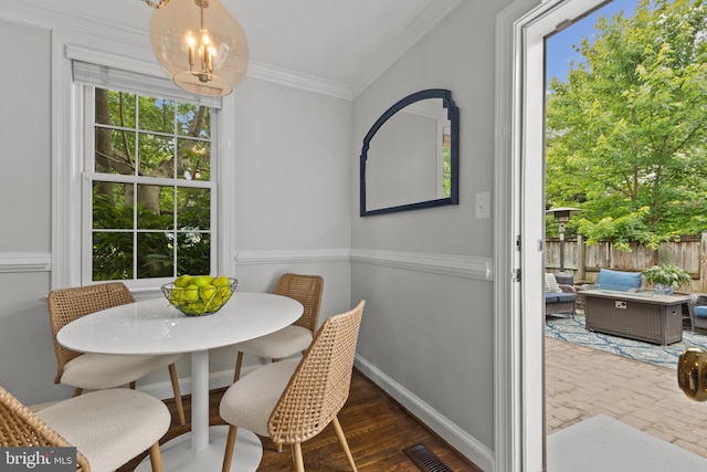 823 Church St, Alexandria, VA 22314 - dining space featuring ornamental molding, a chandelier, wood finished floors, and baseboards