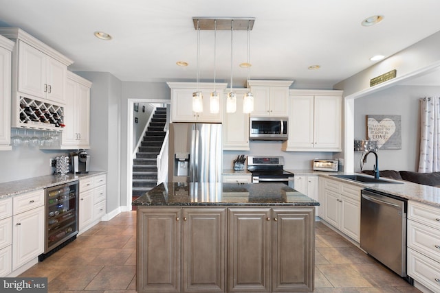 124 Willow Grove Mill Dr, Middletown, DE 19709 - kitchen featuring stainless steel appliances, wine cooler, a sink, a kitchen island, and dark stone counters
