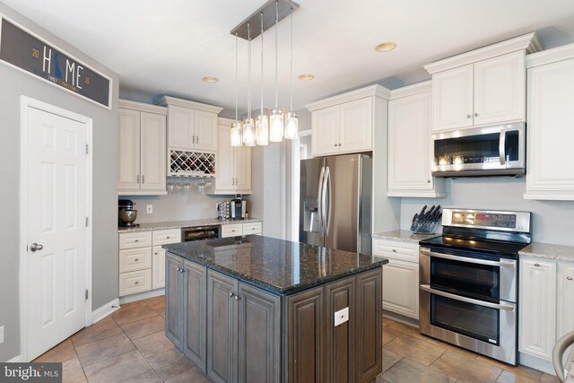 124 Willow Grove Mill Dr, Middletown, DE 19709 - kitchen with stainless steel appliances, a center island, hanging light fixtures, dark stone countertops, and recessed lighting