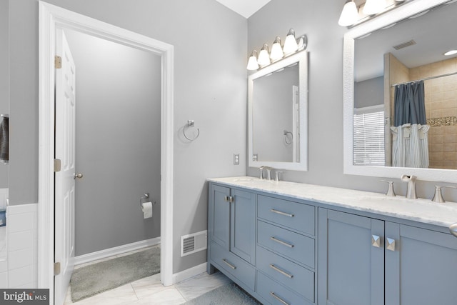 124 Willow Grove Mill Dr, Middletown, DE 19709 - bathroom with double vanity, a tile shower, and baseboards